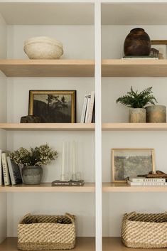 shelves with baskets and pictures on them