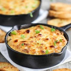 two black pans filled with cheesy bread and green onions