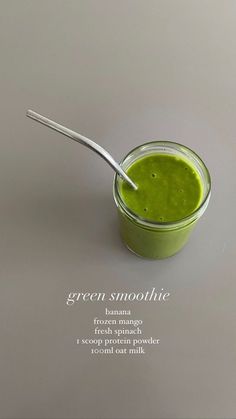 a green smoothie in a glass with a spoon on the side and information about it