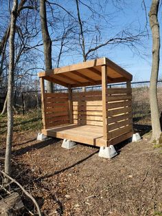 a small wooden shelter in the woods