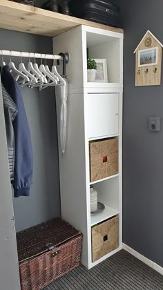 the closet is organized with clothes, baskets and other things to keep them organized in