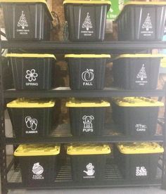 several black and yellow bins stacked on top of each other in a storage rack