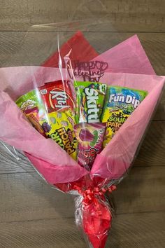 the candy bouquet is wrapped in pink paper