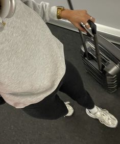 a person with headphones and a suitcase