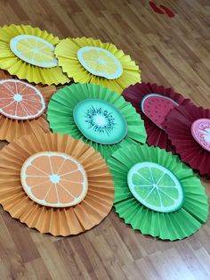 paper plates with different designs on them sitting on a wooden floor next to each other