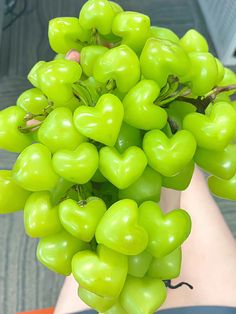 a bunch of green grapes in the palm of someone's hand