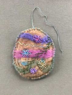 an ornament made out of fabric with flowers on it