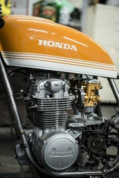 an orange and white motorcycle parked in a garage