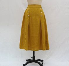 " *Pleated skirt *Hidden pockets *Length approx: 78cm *Wash by hand or machine with cold water *Materials : 100%Linen Auailable in women's us size XXS to 3XL as well as custom size and plus size  XXS: Waist:66cm/26\" Length:78cm/30.5\" XS: Waist:70cm/27.5\" Length:78cm/30.5\" S: Waist:74cm/29\" Length:78cm/30.5\" M: Waist:78cm/30.5\" Length:78cm/30.5\" L: Waist:82cm/32\" Length:78cm/30.5\" XL: Waist:86cm/33.8\" Length:78cm/30.5\" XXL: Waist:90cm/35.5\" Length:78cm/30.5\" 3XL: Waist:94cm/37\" Len Yellow A-line Pleated Skirt, Yellow Flowy Pleated Midi Skirt, Yellow A-line Lined Skirt, Yellow Long Gathered Skirt, Yellow Relaxed Fit Pleated Summer Skirt, Yellow Relaxed Knee-length Skirt, Yellow Pleated Skirt With Relaxed Fit For Summer, Yellow Long Pleated Summer Skirt, Yellow Long Pleated Skirt For Summer