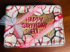 a birthday cake decorated with baseballs and the words happy birthday ell