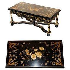 a black and gold table with flowers on it