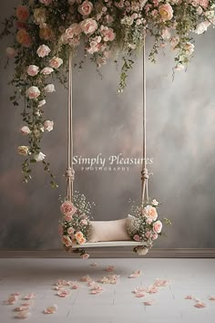 a swing with flowers hanging from it in front of a wall