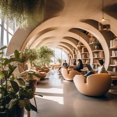 people are sitting in chairs and reading books at the same time as they sit on couches