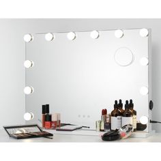 a vanity mirror with lights and cosmetics on it