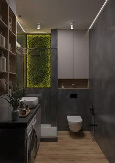 a modern bathroom with wood flooring and gray walls, along with a plant on the wall