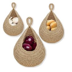 two baskets with onions and mushrooms in them on a white background, one is holding an eggplant