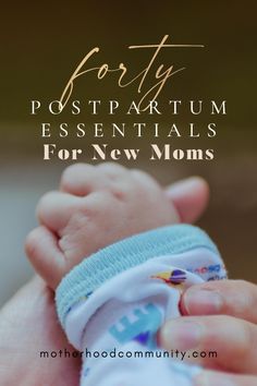 a hand holding a baby's arm with the words forty postpartum essentials for