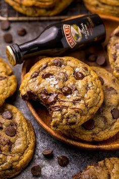 chocolate chip cookies on a wooden plate with a bottle of beer