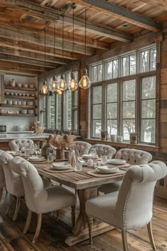 the dining room table is set with white chairs