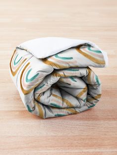 a blanket folded on top of a wooden table