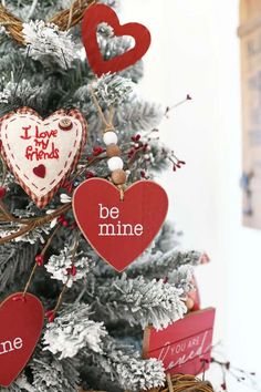 christmas tree decorated with red and white heart ornaments, saying i love my friends be mine