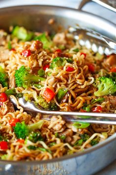 a close up of a bowl of food with broccoli and noodles in it