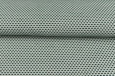 a close up view of a green and white checkerboard pattern on the fabric