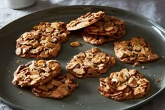 several cookies are arranged on a plate next to a cup