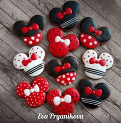 mickey and minnie mouse cookies are arranged in the shape of heart shaped hearts on a wooden table