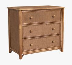 a wicker dresser with three drawers and two handles on each drawer, against a white background