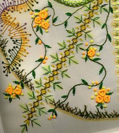 an embroidered piece with yellow flowers on it