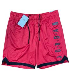 Elevate your activewear game with these Nike Air Jordan basketball shorts in a bold red colorway. These shorts feature an elastic waistband and drawstring closure for a secure fit during any athletic activity. With pockets for added convenience, these shorts are perfect for school, crossfit, or basketball. Made from 100% polyester fabric, these shorts are machine washable for easy care. The solid pattern and Jordan logo theme make these shorts a stylish addition to any sports enthusiast's wardrobe. Available in men's size M, these athletic shorts are a must-have for any summer, fall, or spring season. Logo Theme, Jordan Logo, Jordan Basketball, Active Wear Shorts, Basketball Shorts, Spring Season, Solid Pattern, Athletic Shorts, Nike Air Jordan