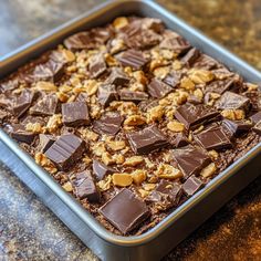 a pan filled with chocolate and nuts on top of a counter