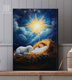 a painting of a baby jesus in the manger with his lamb on top of hay