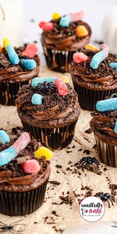 A table full of decorated dirt gummy worm cupcakes and spiders. Gummy Worm Cupcakes, Worm Cupcakes, Bug Themed Treats, Worms In Dirt Cupcakes, Dirt Worm Cupcakes, Halloween Birthday Party Cupcakes, Bug Themed Cupcakes, Bug Cupcakes For Kids, Bug Party Cake