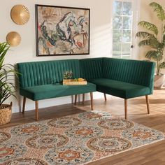 a living room with two green couches and a rug