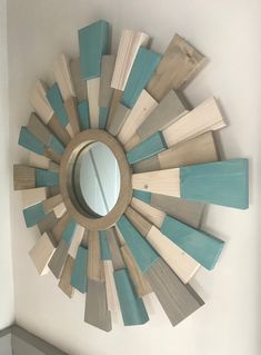 a circular wooden mirror mounted to the side of a wall