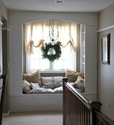 a window seat with a wreath hanging from it's side