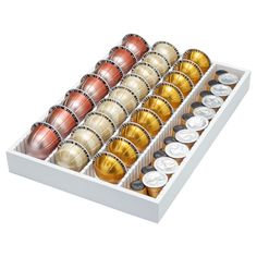 a white box filled with lots of different types of balls and coins on top of each other