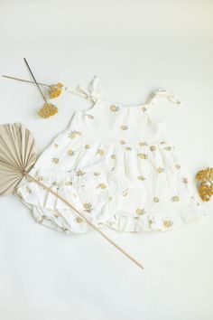 Introducing our delightful  Lemon Set" - a charming ensemble designed to brighten up your little one's wardrobe with a burst of freshness! Crafted from 100% gauze organic cotton, this set is not only adorable but also incredibly soft and gentle against your baby's delicate skin. Embrace the sunny vibes of spring and summer with our cute lemon prints, adorning both the top and bloomers. The main fabric is off-white with small lemon prints, adding a subtle yet cheerful touch to the ensemble. The p Cute Printed Cotton Set, Summer Cotton Sets In Cream Color, Summer Cotton Cream Set, Cute White Printed Sets, Playful White Floral Print Sets, Summer Cream Cotton Set, Playful Cotton Bloomers For Beach, Playful Cotton Bloomers For The Beach, Playful Cotton Sets For First Birthday