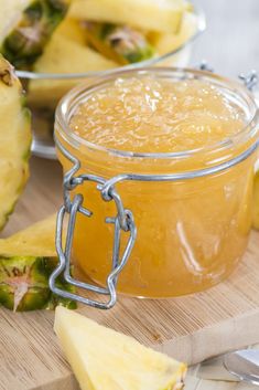 pineapple jam in a glass jar on a cutting board