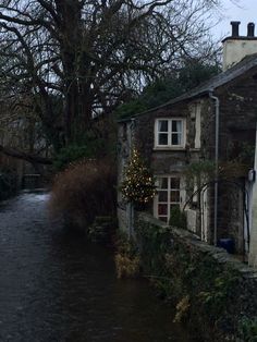 a river running through a small village next to a building