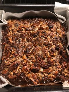 a baking dish with pecans in it