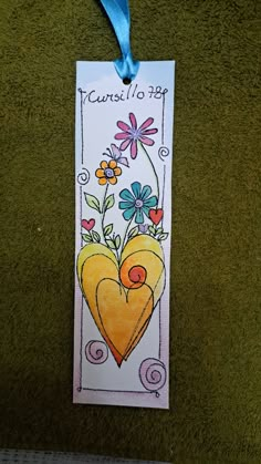 a bookmark with a heart and flowers on it