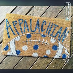 a door mat with the name appalachai on it and a football design