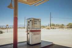 an old fashioned gas pump in the middle of nowhere