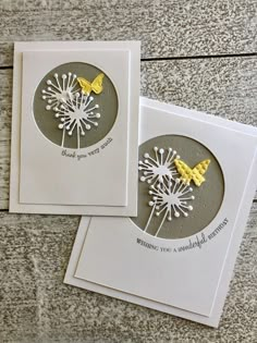 two greeting cards with dandelions on them, one yellow and the other white