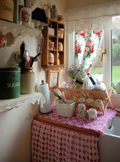 a kitchen filled with lots of clutter and cooking utensils