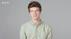 a man in a green shirt posing for the camera