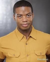 a man in a yellow shirt posing for a photo